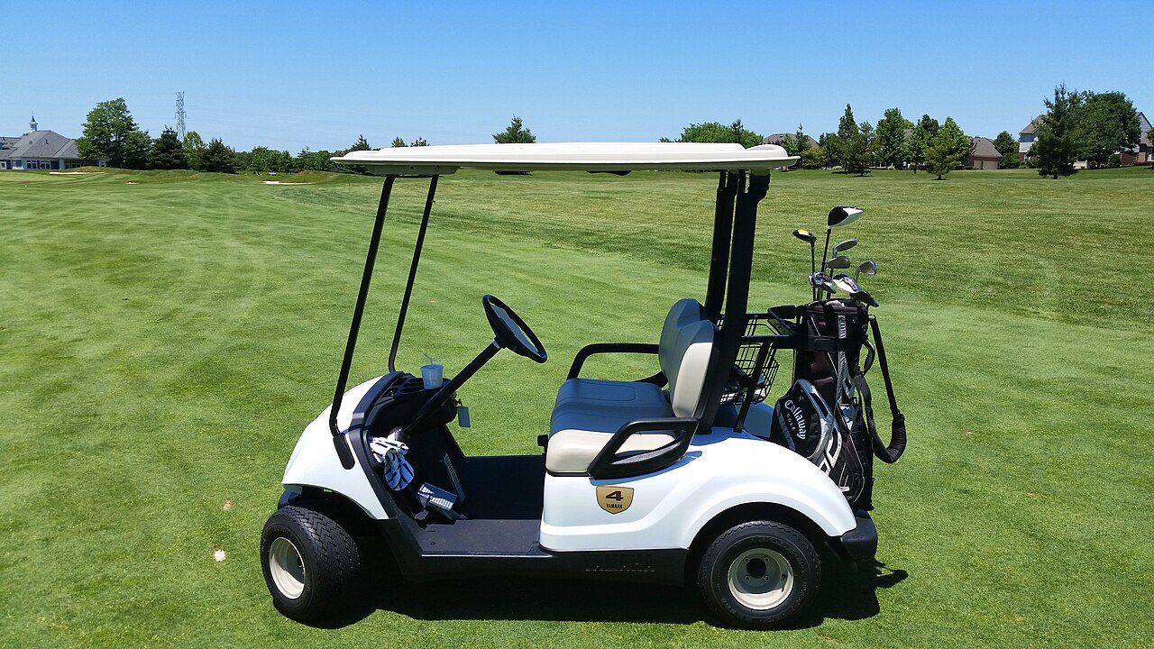 Golf cart fitted with lights and mirrors
